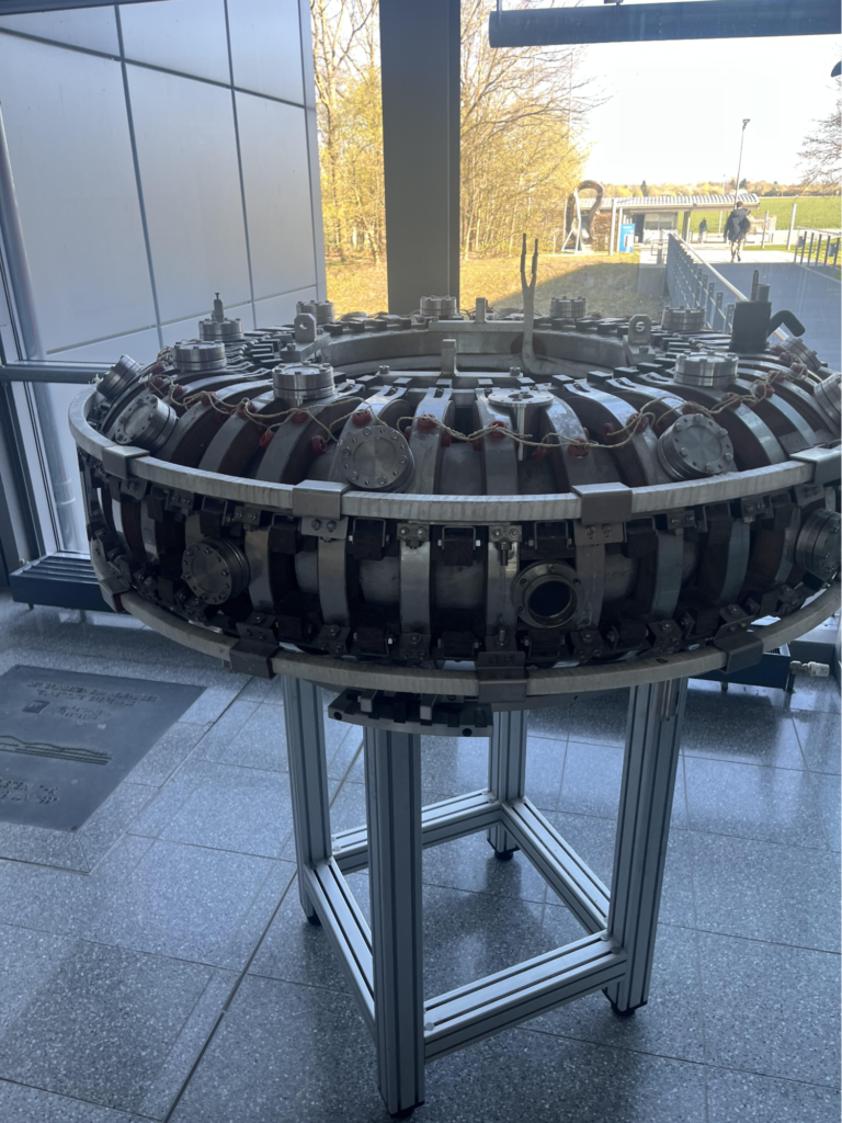 A circular metalic structure in a lab setting.