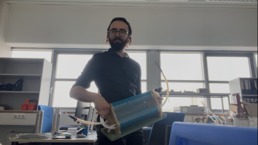 A man holds an asymmetric, 1 MHz transformer moments prior to installation on source 7 at W7-X.